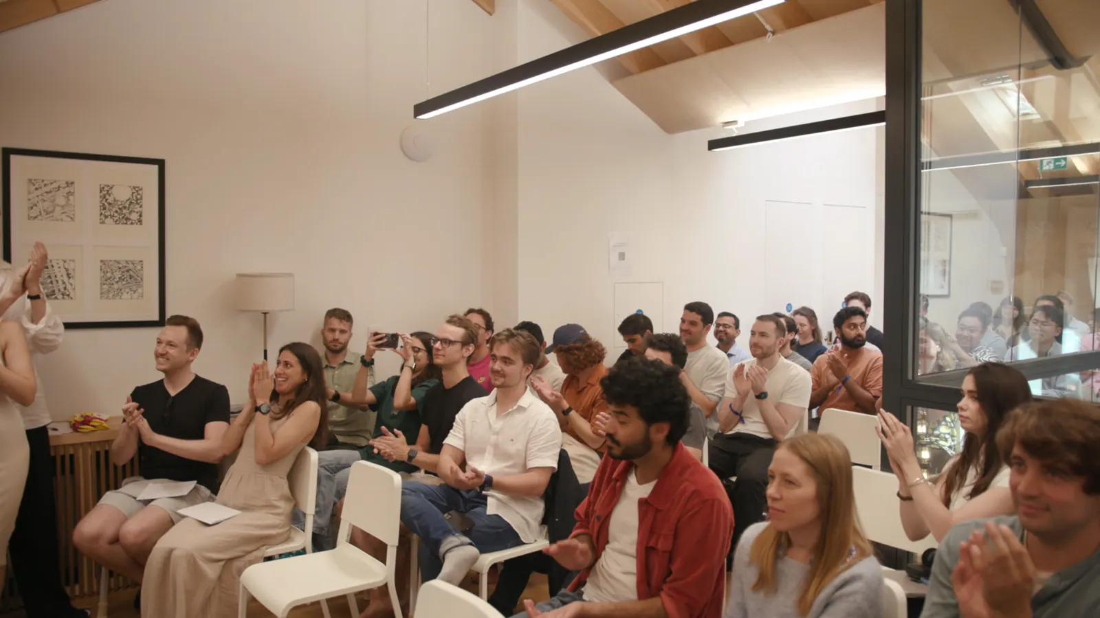 Participants applauding during the final team demonstrations at Building an AI Scientist, 50Y, Soho Square, London